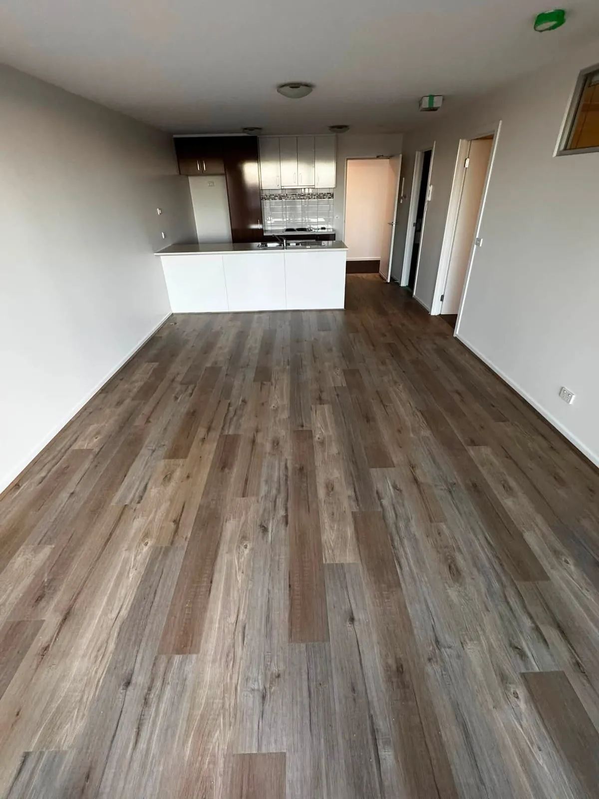 The same living room with new timber-look hybrid flooring